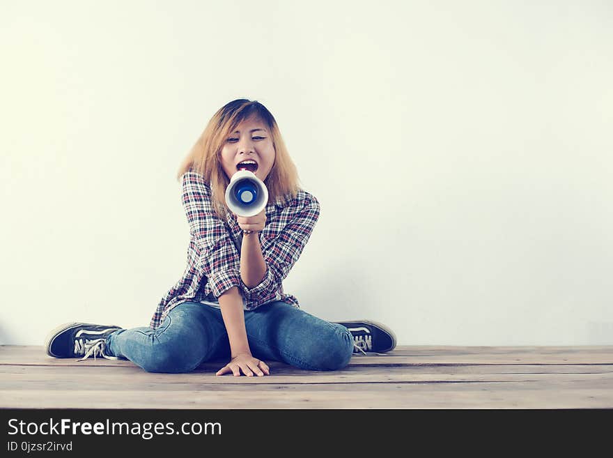 Young Hipster Woman Shouting Through Megaphone.