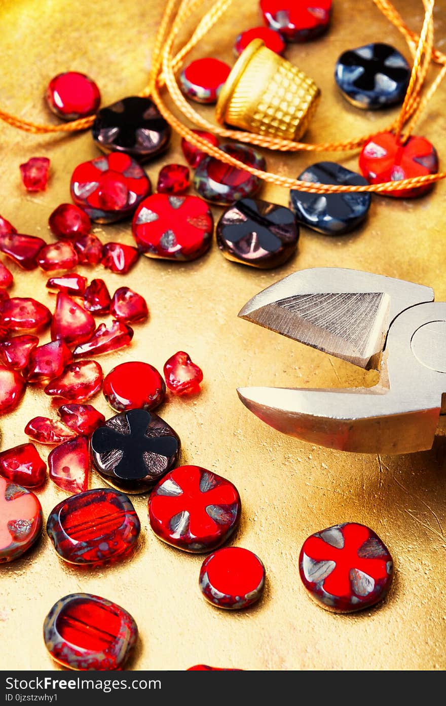 Making necklaces of glass beads.