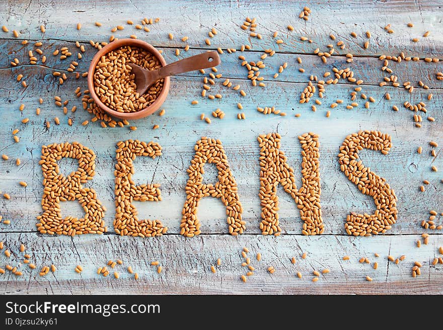 Beans on the table bakground with bowl and spoon