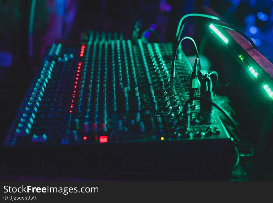 Sound mixing console in a nightclub. Dark soft blurry photo