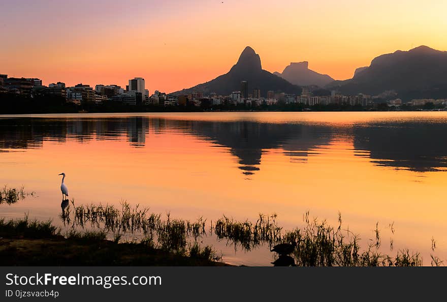 Beautiful View of Rio de Janeiro Sunset Behind Mountains at Rodrigo de Freitas Lake.