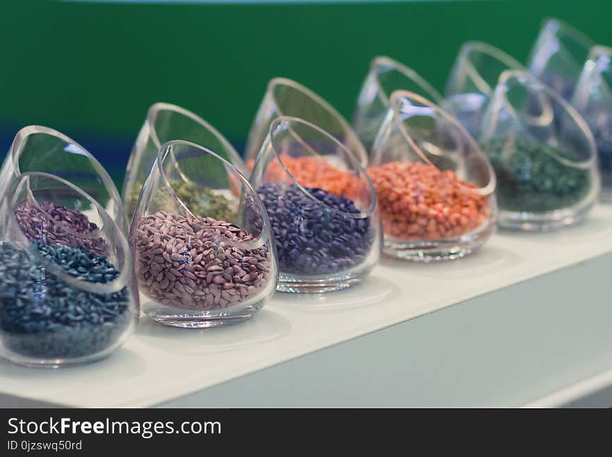 Multicolored seeds on the exhibition stand. Agriculture