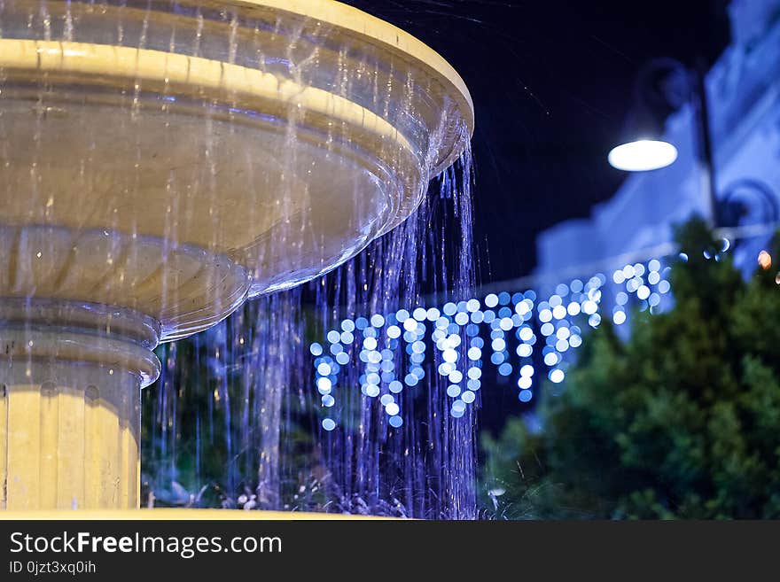 Fountain on the street in the evening.