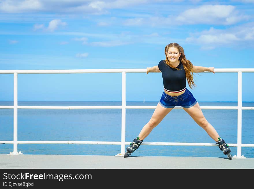 Girl wearing roller skates on seaside