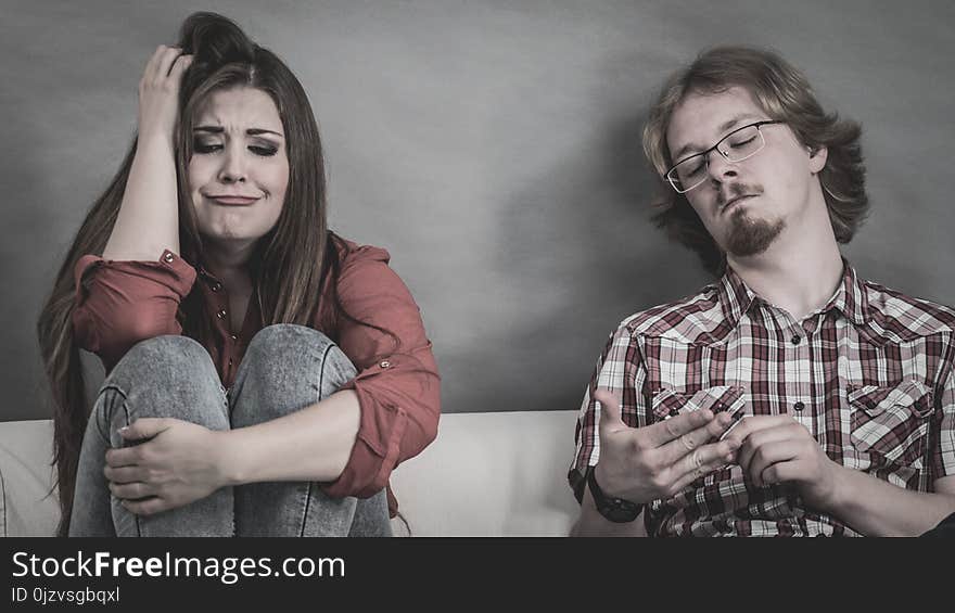 Woman and man after argue on sofa