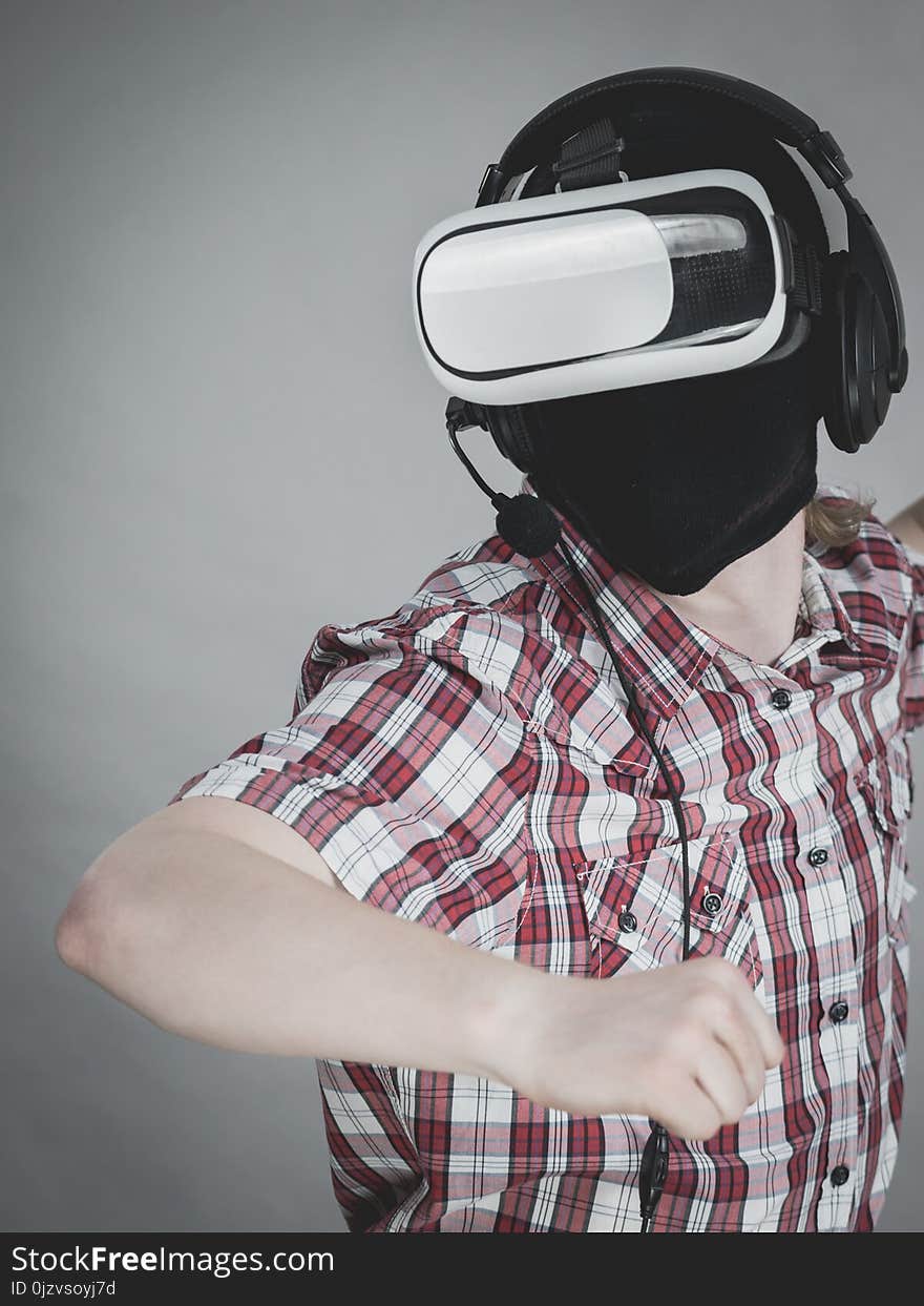 Man playing video game wearing virtual reality device. Gaming equipment for gamers concept. Man playing video game wearing virtual reality device. Gaming equipment for gamers concept.