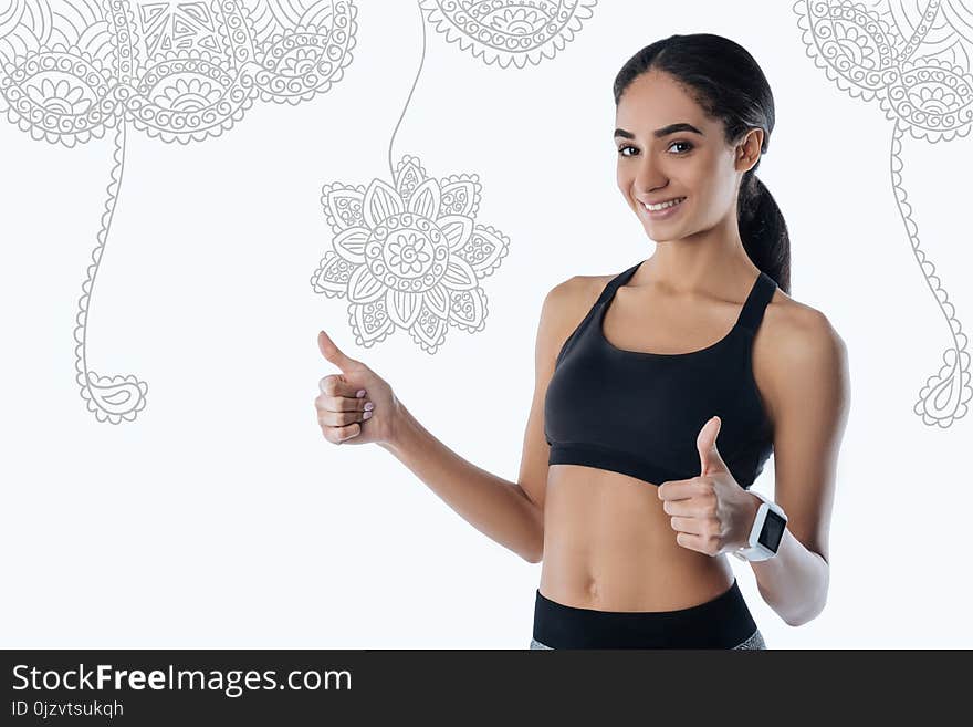 Kind trainer putting her thumbs up and smiling to her pupils