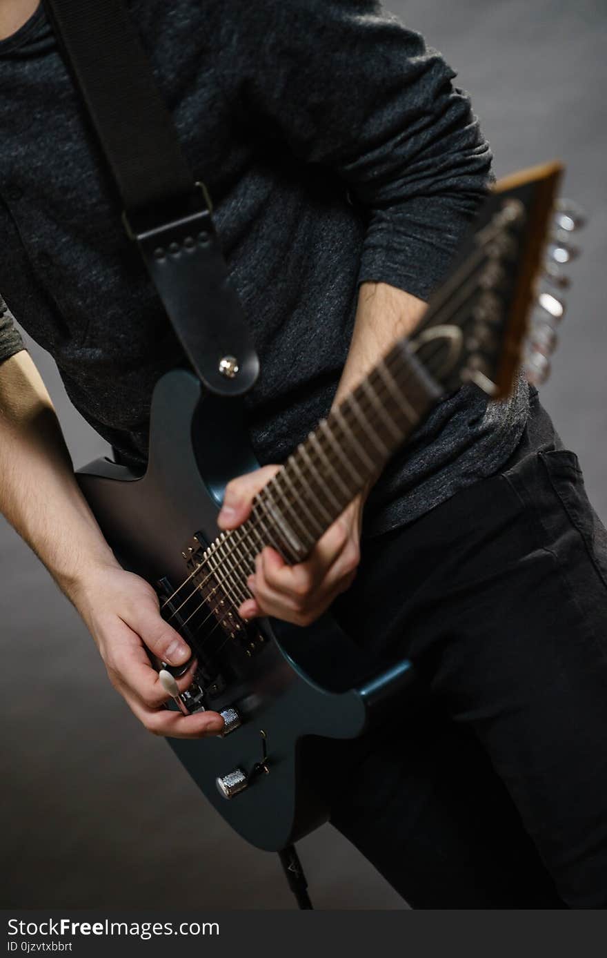 Male hands with electric guitar. Close up, part body adult person is holding instrument and playing. Hobby, music concept. Male hands with electric guitar. Close up, part body adult person is holding instrument and playing. Hobby, music concept