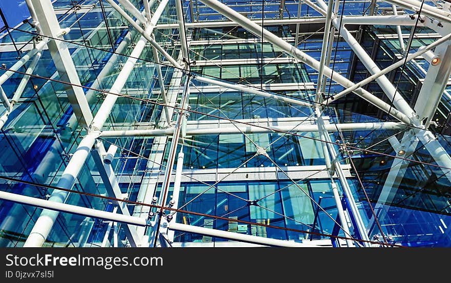 Metallic pipes and cords construction in a building with big windows