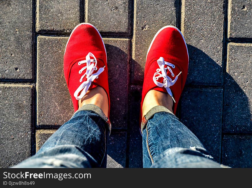 Paving slabs, red sneakers, white laces