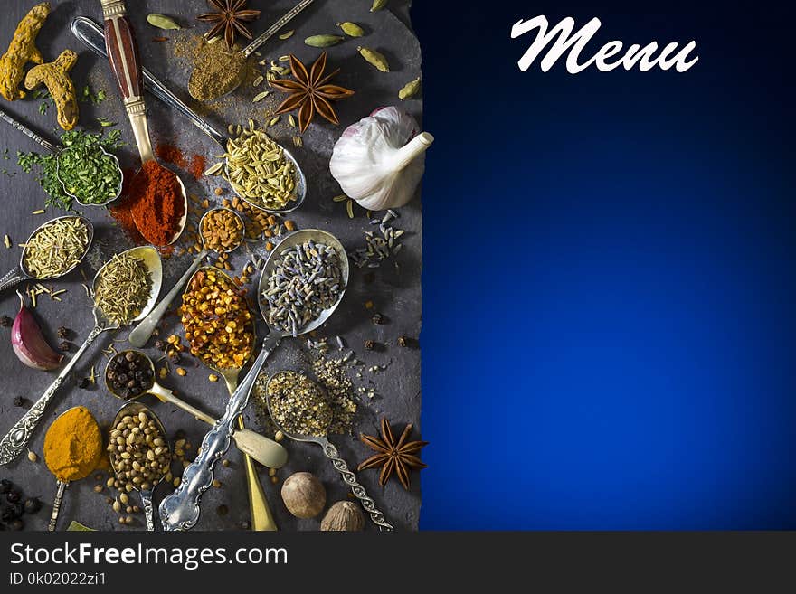 Spices on spoons - a selection of spices used to add flavor to cooking. Spices on spoons - a selection of spices used to add flavor to cooking.