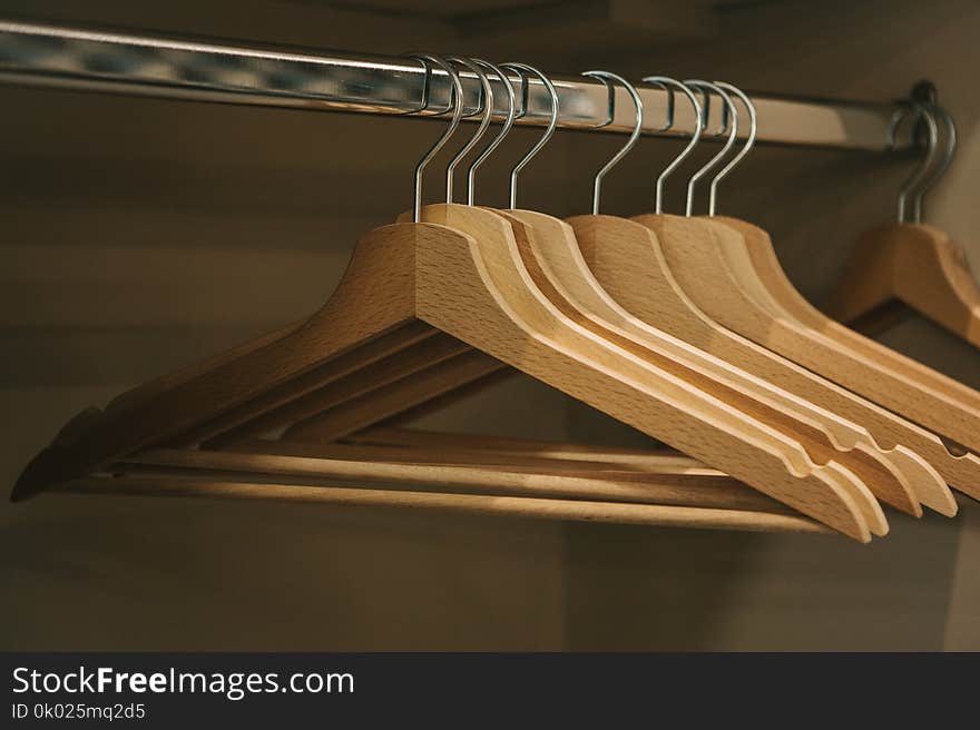 Empty hangers hang in a row in the closet