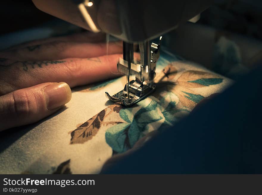 Tailor at Work on Sewing Machine with human hand