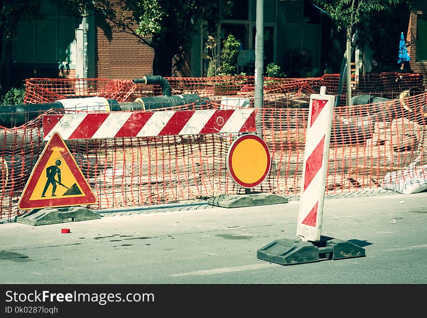 Work Ahead Street Reconstruction Site With Sign And Fence As Road Barricade