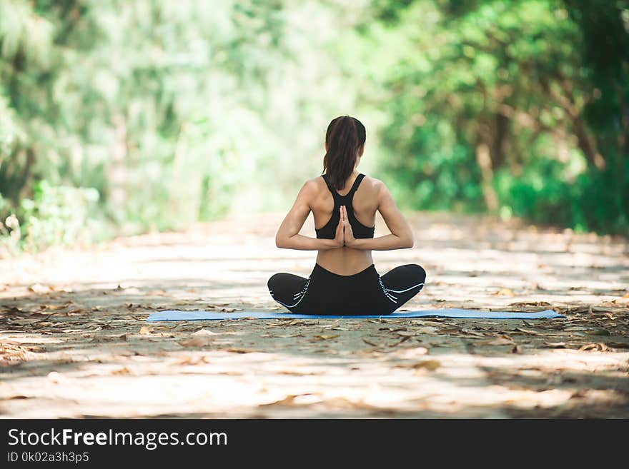 Young Asian Woman Doing Yoga In The Morning At The Park. Healthy