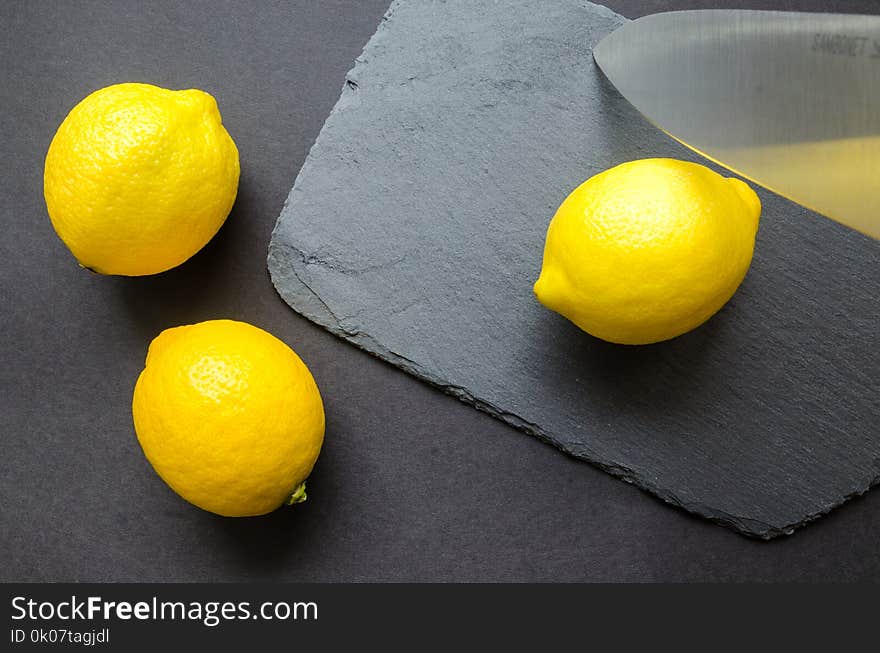 Three Lemons on Grey Surface