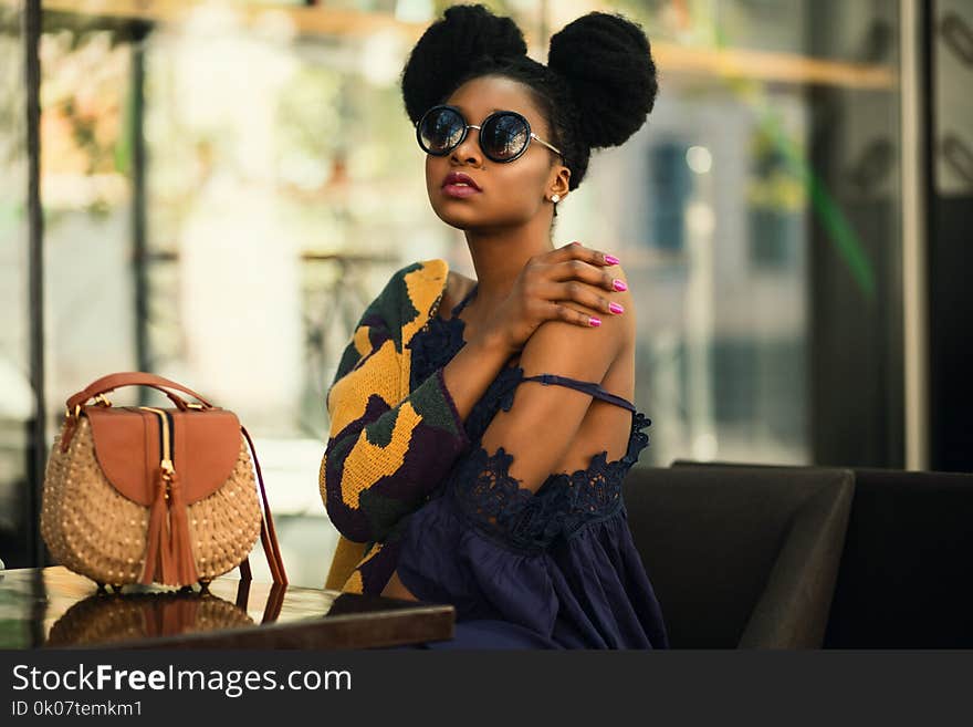 Shallow Focus Photography of Woman Wearing Gray and Yellow Spaghetti Strap Dress Sitting on Chair