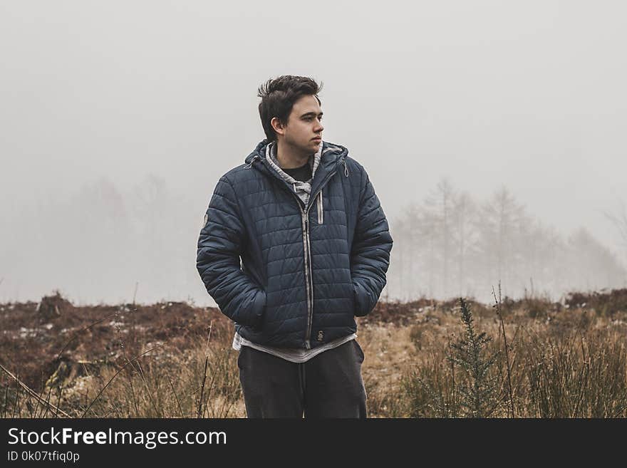 Man Wearing Black Zip-up Hooded Jacket Standing