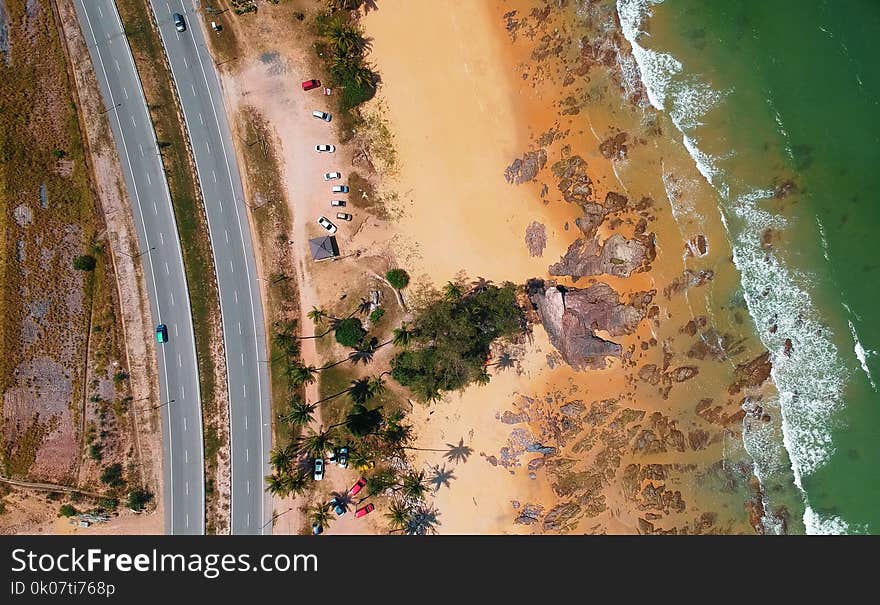 Aerial Photo of Seashore Near Two Lanes of Wide Road