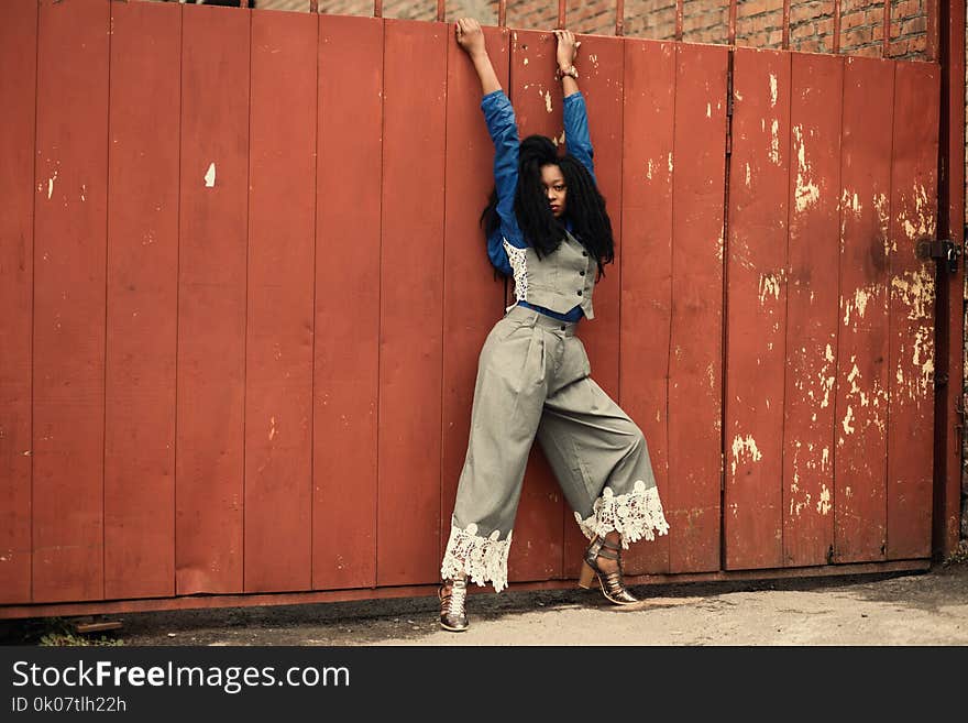 Woman in Gray and Blue Long-sleeved Shirt and Gray Pants