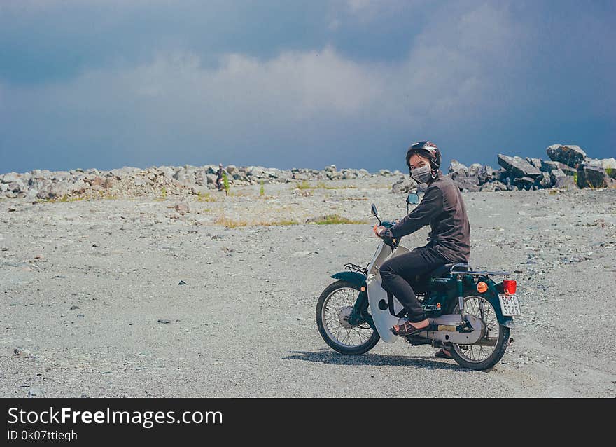 Person Wearing Mask on Motorcycle