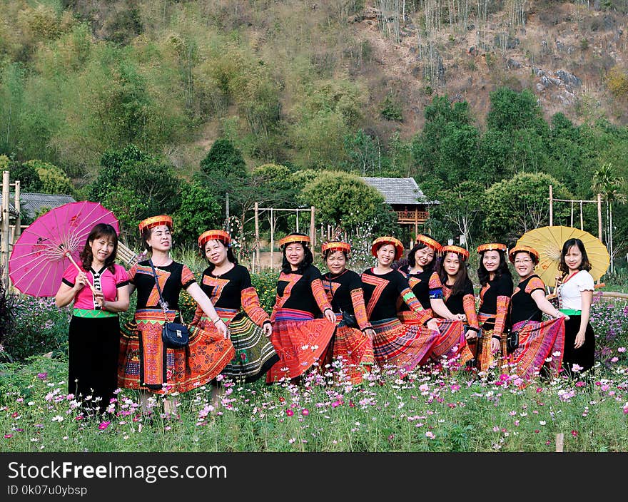 Women Standing in the Middle of Pink Flower Field