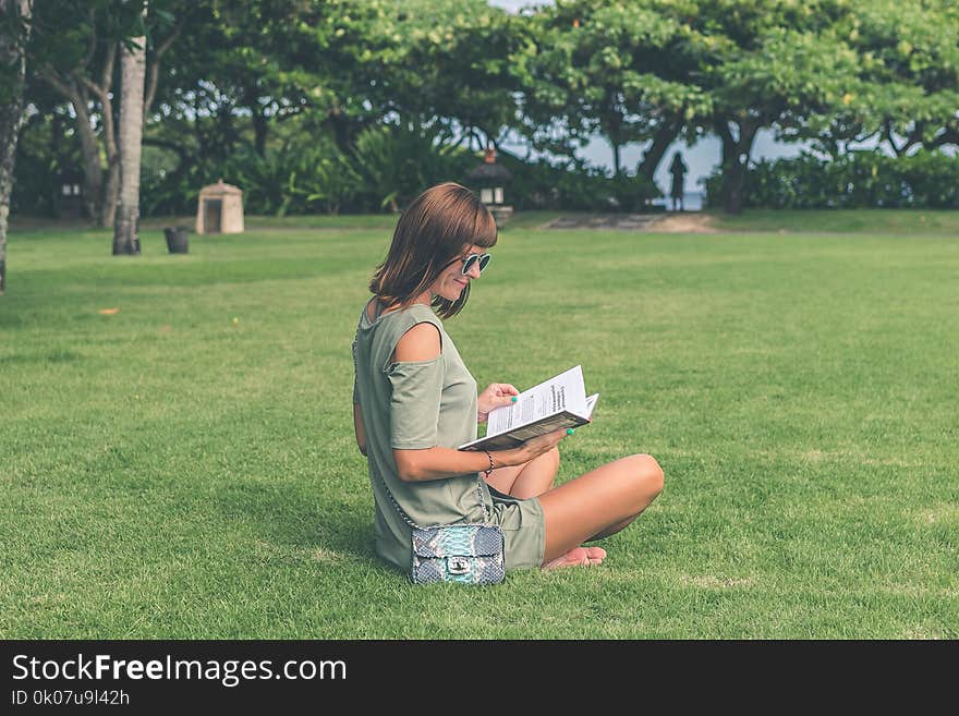 Woman Wearing Green Top Reading Book