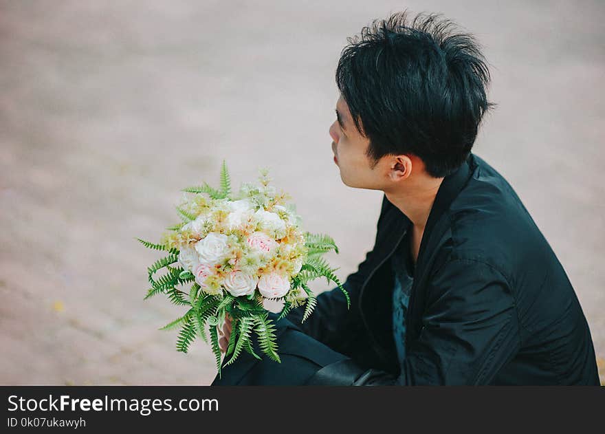 Person Holding Bouquet of Roses