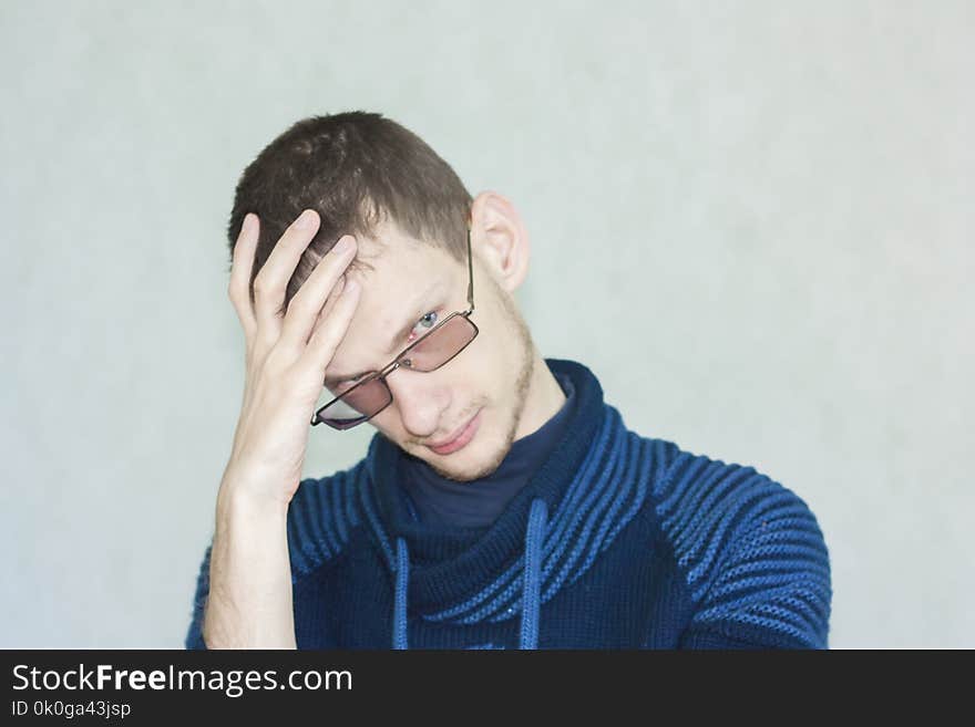 idea and idea concept. manadzhits hand near the head. attractive young man in a blue blouse on a white background