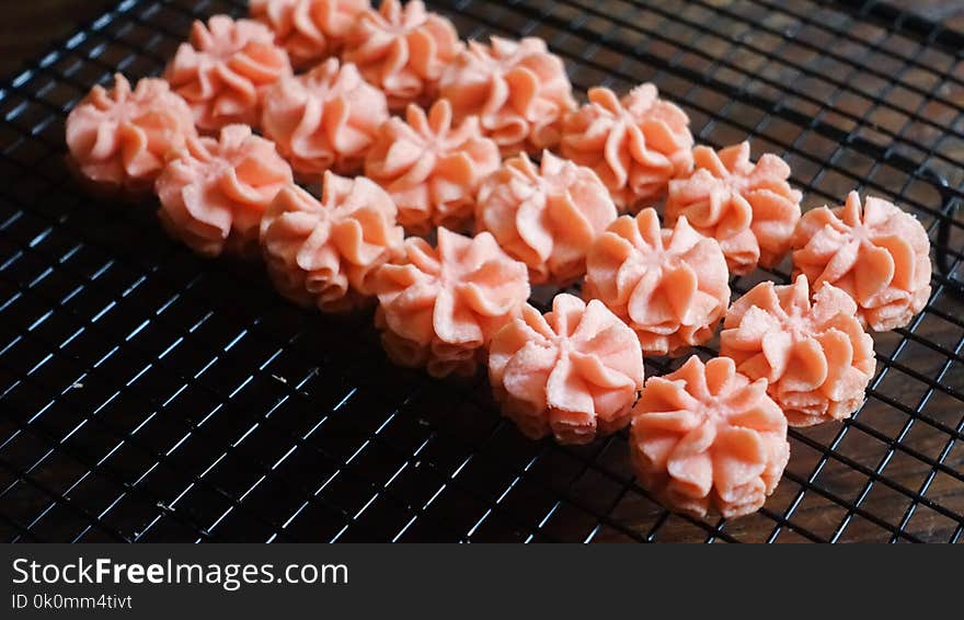 Close-up Photo of Pink Icing on Black Screen