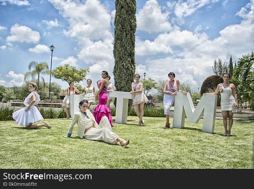 Group of Woman on Green Grass Field