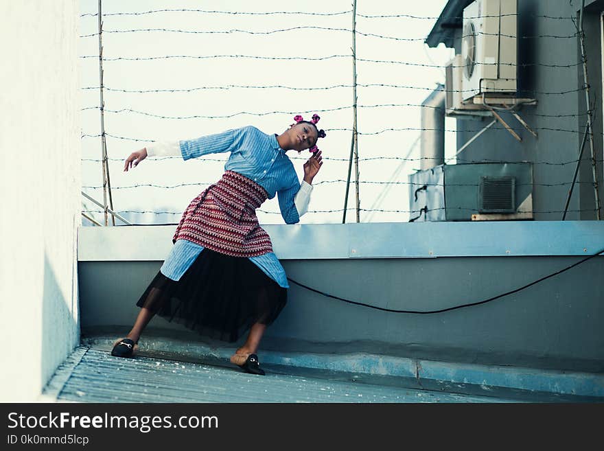 Woman in Blue Button-up Long-sleeved Top and Black Skirt