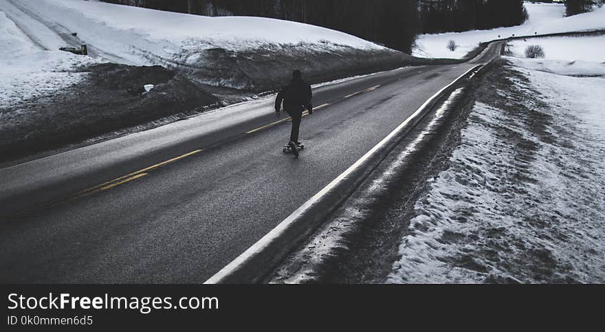 Person Running on Asphalt Road