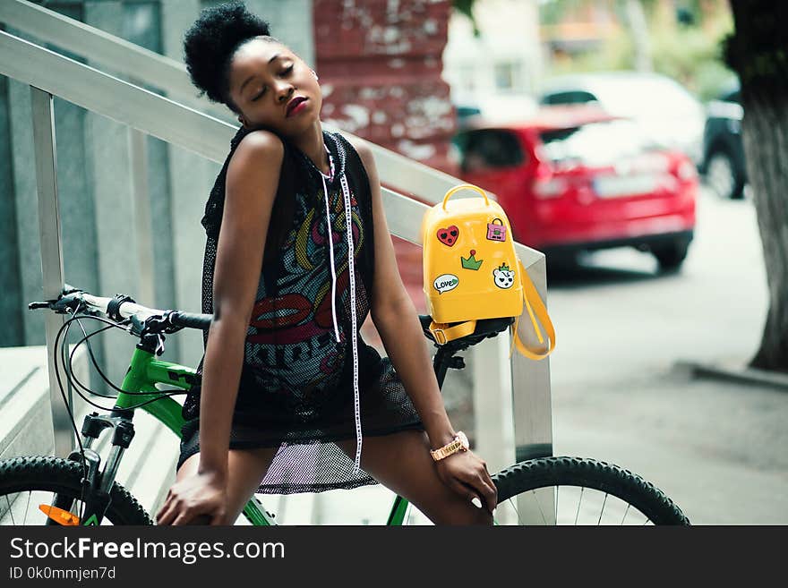 Woman Wearing Black Sleeveless Top With Green Hardtail Bicycle at the Back