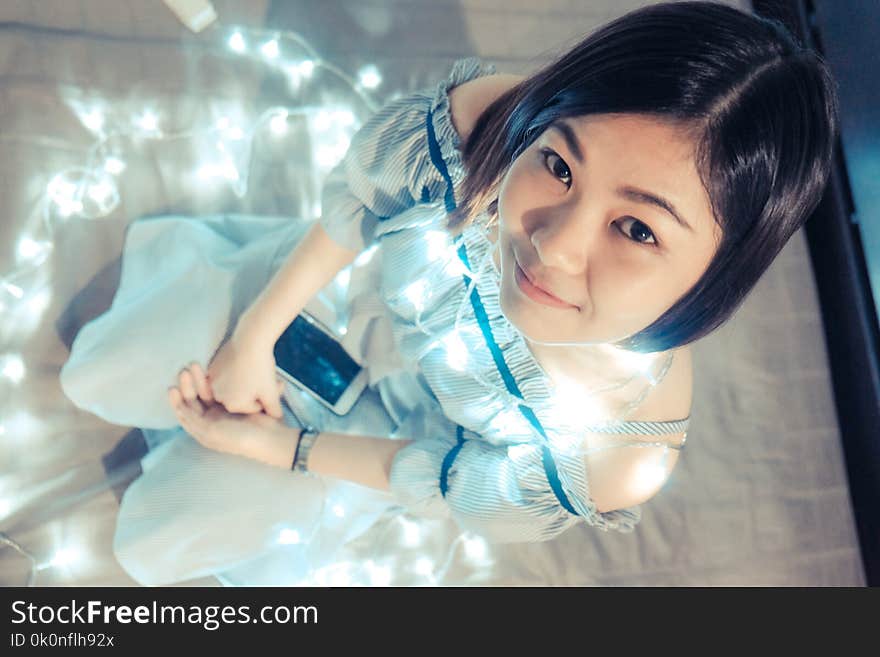 Beautiful Women Relaxing On Cozy Bed With Light