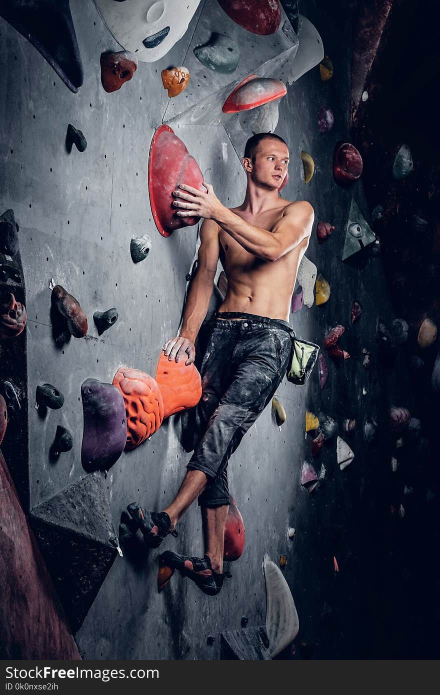 Man climbing on an indoor climbing wall.