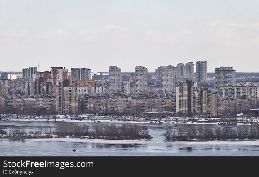 Kiev, March 24, 2018, Ukraine. View Of The City And Real Estate Through The Winter River In The Ice