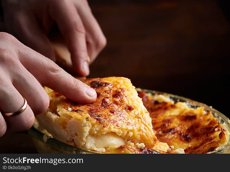 A Piece Of Lasagna Cooked In A Glass Pan Over Vintage Wooden Background, Top View, Close-up, Selective Focus