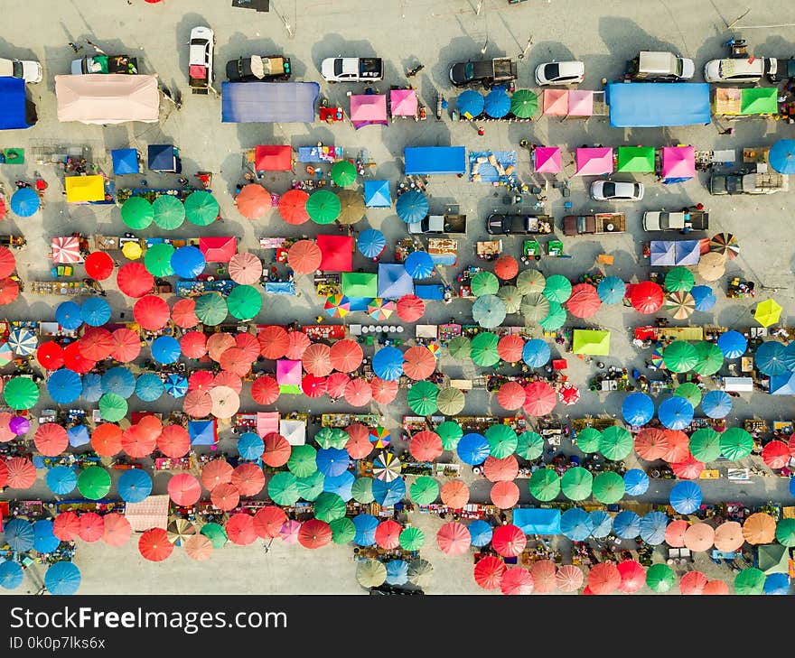 Aerial view from camera drone of flea market with colorful umbrellas and tents under evening sunlight, Thailand. Aerial view from camera drone of flea market with colorful umbrellas and tents under evening sunlight, Thailand