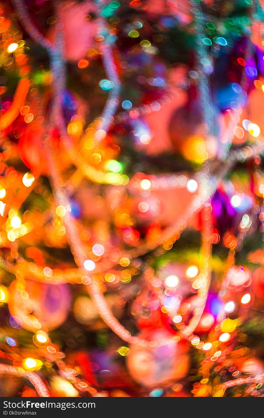 Decorated Christmas tree and colorful garland lights, defocused background, bokeh effect. Decorated Christmas tree and colorful garland lights, defocused background, bokeh effect.