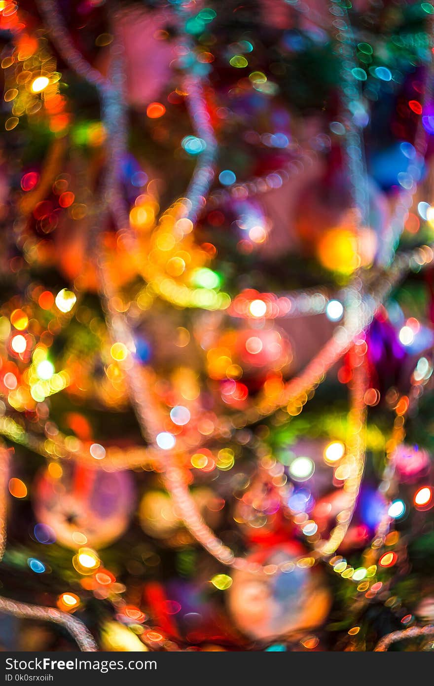 Decorated Christmas tree and colorful garland lights, defocused background, bokeh effect. Decorated Christmas tree and colorful garland lights, defocused background, bokeh effect.