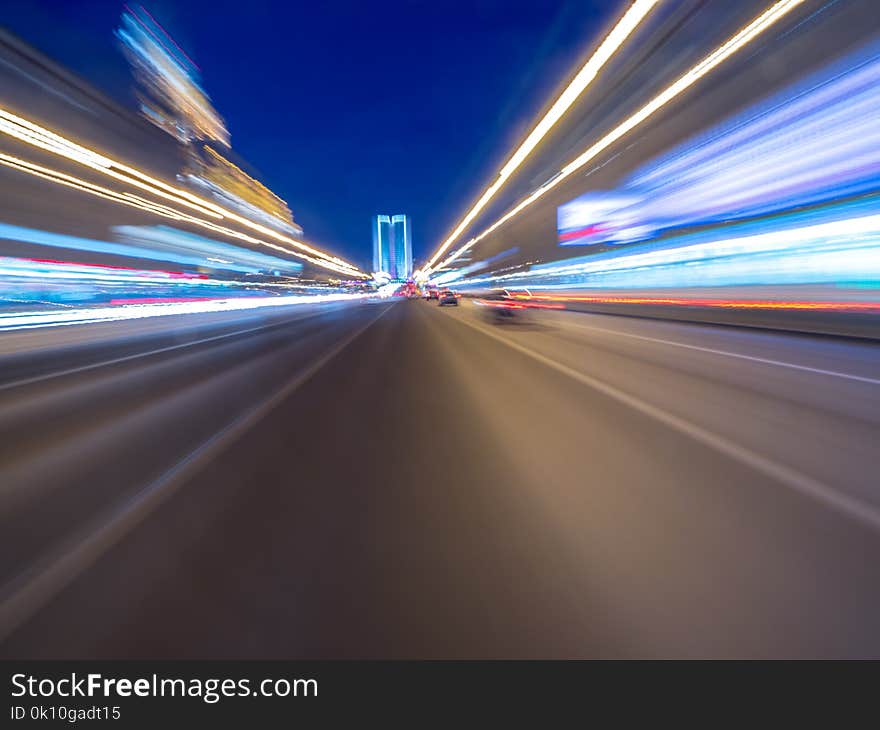 Speed motion on the neon glowing road at dark. Speed motion on the road. Colored light streaks acceleration. Abstract illustration. Blue and Orange Yellow motion streaks.