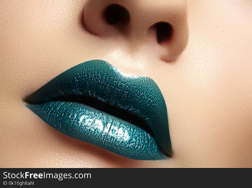Glamour green Gloss Lips with sensuality gesture. style, closeup macro shot of female Lip stick Make-up. Sensuality mouth