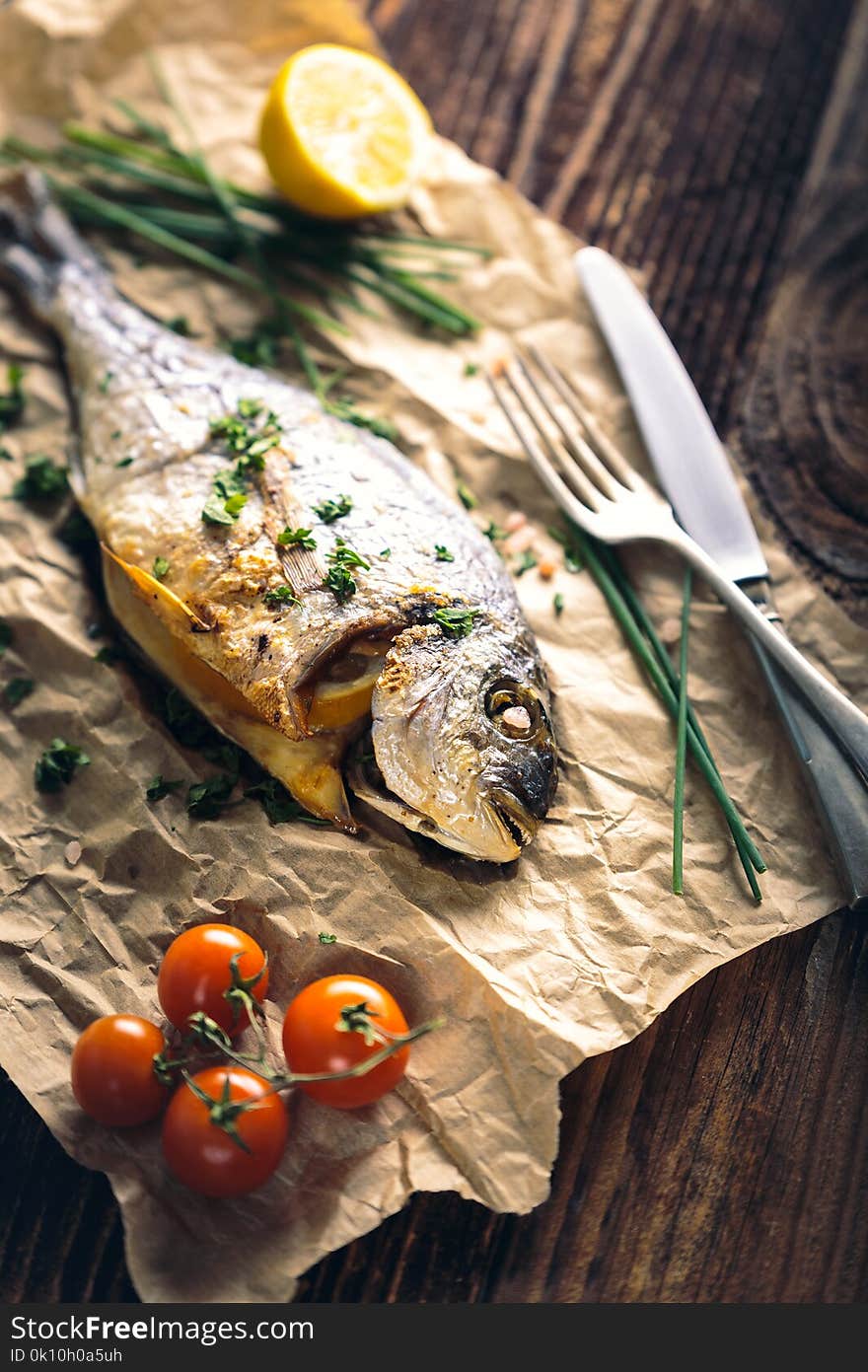 Gilthead seabream & x28;Sparus aurata& x29; baked in the oven with lemon, chive and salt. Gilthead seabream & x28;Sparus aurata& x29; baked in the oven with lemon, chive and salt.