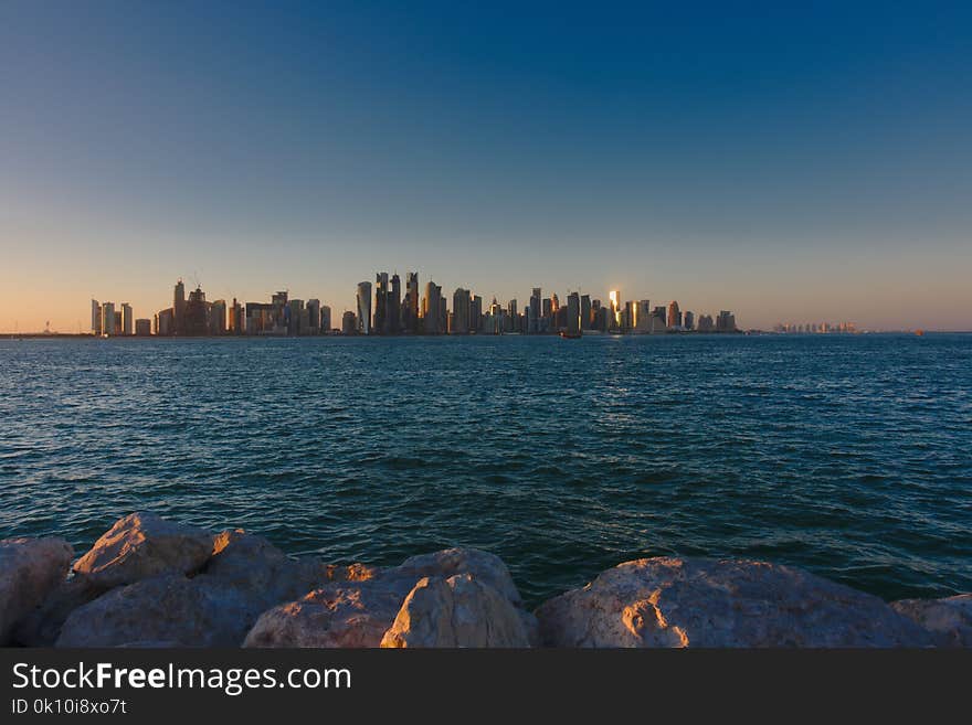 Skyline of West Bay skyscrapers, taken at sunset from the Dhow Harbour. Doha, Qatar. Skyline of West Bay skyscrapers, taken at sunset from the Dhow Harbour. Doha, Qatar.