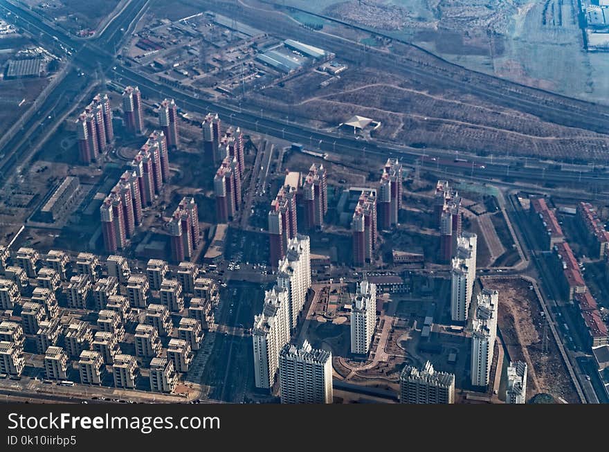 Looking down from an airplane on a residential districts with skyscrapers in Peking Beijing. Looking down from an airplane on a residential districts with skyscrapers in Peking Beijing