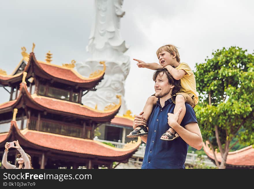 Happy tourists dad and son in Pagoda. Travel to Asia concept. Traveling with a baby concept.