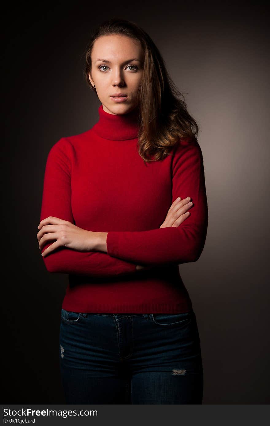 Creaqtive portrait of a beautiful young caucasian happy woman in red wool kneeted sweater