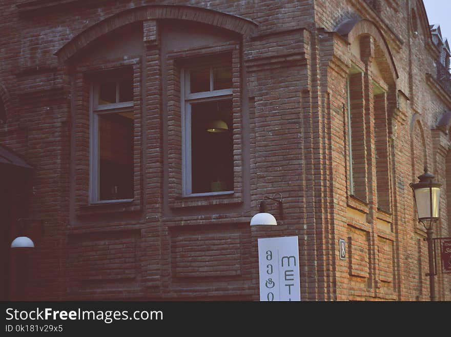 Brown Stone Brick Building Near Black Lamp Post