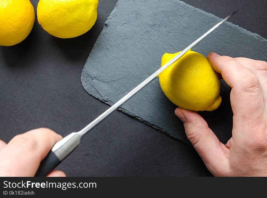 Photo of Person Slicing Lemon